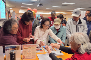 Crowd of people around a table
