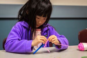 a young child starting a crochet project