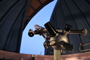 telescope in observatory pointed towards sky